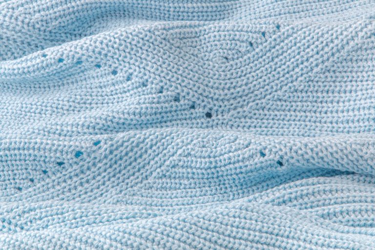 Loose knit blue baby blanket.