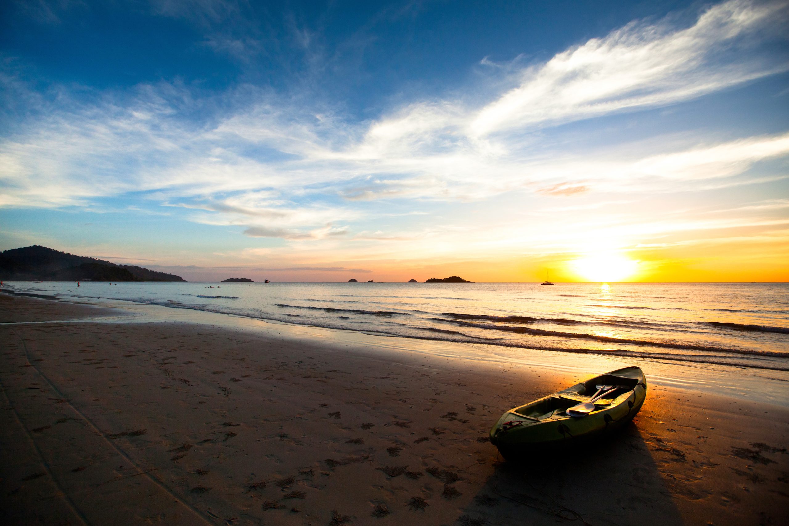 Kayak on the beach at sunset in Thailand.