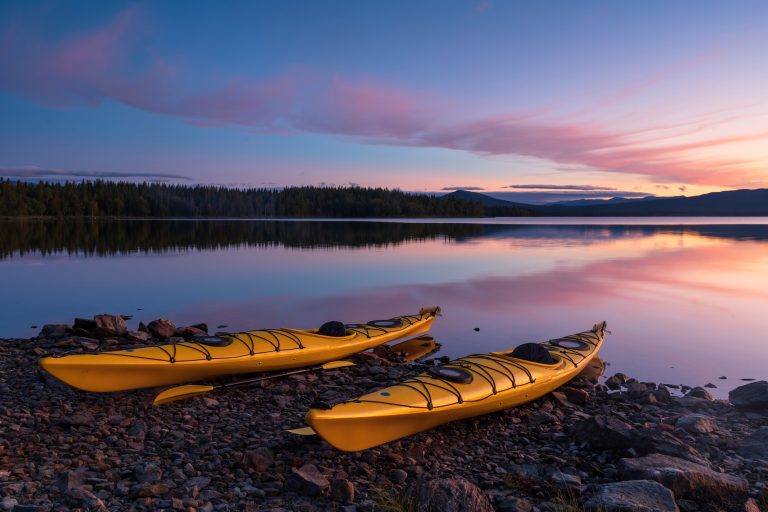 Two kayaks on a shore during dusk