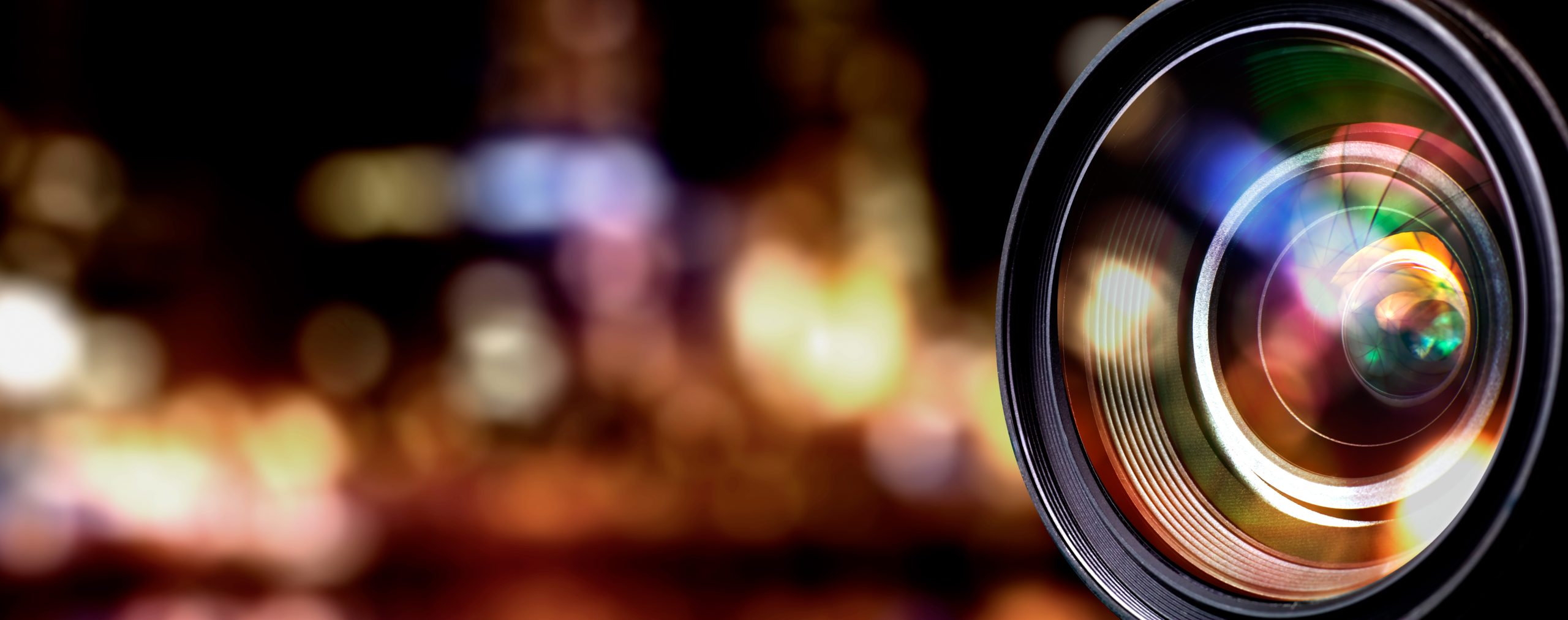 A camera lens in view with a blurred background.